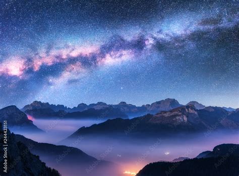 Milky Way Above Mountains In Fog At Night In Autumn Landscape With
