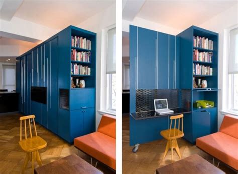 A murphy bed folds against the wall when not in use. Smart Design - Studio Apartment - Downsize My Space