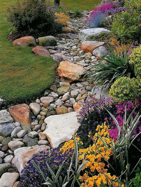 Stones can also double as a garden bed edge, keeping soil in place and minimizing erosion. HOME DZINE Garden Ideas | Pebble and rock river bed for ...