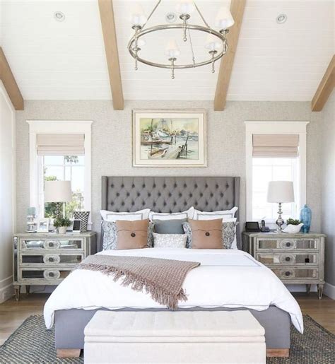 A contrasting bedroom wiht a an elegant moody bedroom with dark walls, a catchy chandelier, artworks, an animal rug and leather chairs. 50+ Romantic Coastal Bedroom Decorating Ideas - Page 37 of 51