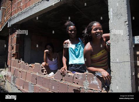 Young Women Pose For A Photo In Latin Americas Largest Favela Or Slum Rocinha In Rio De Janeiro