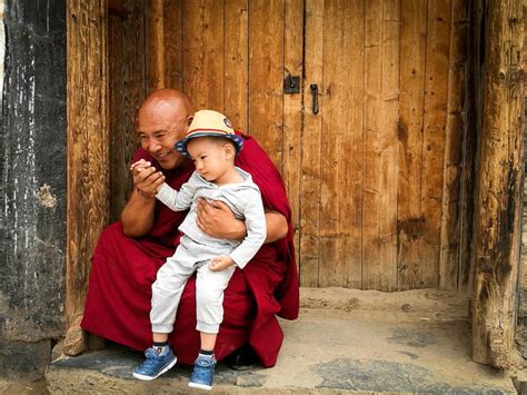 Monk With Boy Crouching By Door Id 92133055