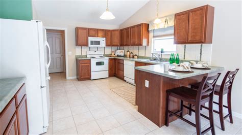 Kitchen with bottom, overhead and loft cabinetry on three sides with an extended breakfast counter. Modular Kitchens - Best Interior Designers for Home ...