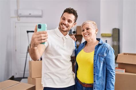 Mother And Son Make Selfie By The Smartphone At New Home Stock Photo