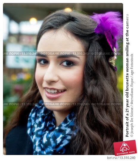 portrait of a 21 year old brunette woman smiling at the camera Стоковое фото № 13310240