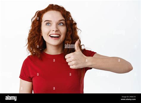 very good awesome excited ginger girl with pale skin looking amazed at logo banner and show