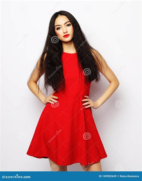 Young Beautiful Woman Wearing Red Dress Posing Over White Background
