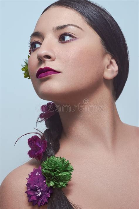 vertical shot of a caucasian female with purple lips and flowers in her hair stock image image