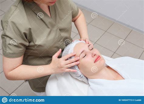 Masseuse Does Face Massage To Woman In Medical Clinic Stock Image