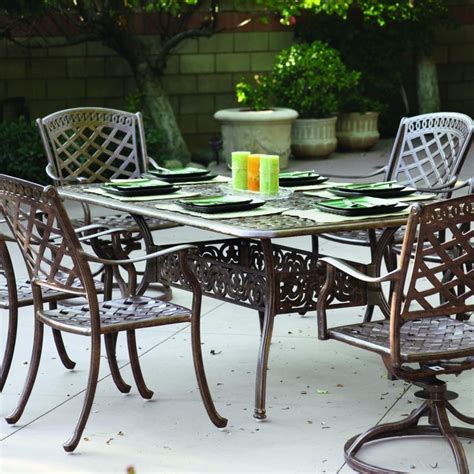 An Outdoor Dining Table With Chairs And Plates On It
