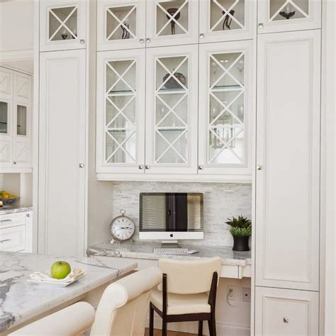 Kelly wearstler imperial trellis wallpaper on back of glass front cabinets add character and style in a small contemporary kitchen featuring a concealed vent hood over a stainless steel stove. 20 Beautiful Kitchen Cabinet Designs With Glass