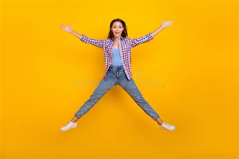 Full Length Photo Of Carefree Funny Lady Jump Raise Hands Wear Plaid