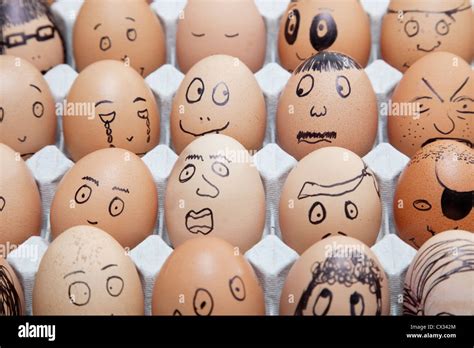 Funny Faces On Painted On Brown Eggs Arranged In Carton Stock Photo Alamy
