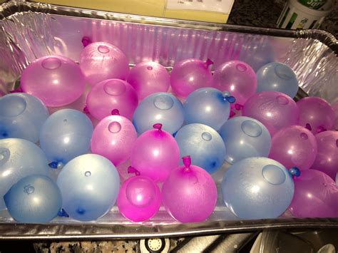 There Are Many Balloons In The Pan On The Stove Top And One Is Pink And