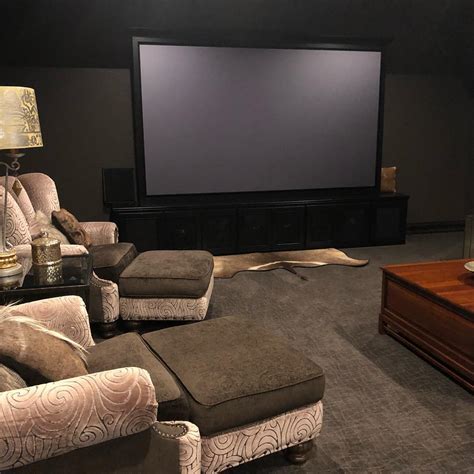 You can make a media room with tiered seating and brown leather chair combined with wood wall with some square painting. 8 Ideas for Designing Your Ultimate Media Room ...