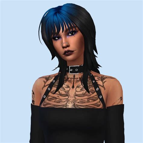 A Woman With Blue Hair And Tattoos On Her Chest Is Wearing A Black Top That Has Cutouts At The Neck