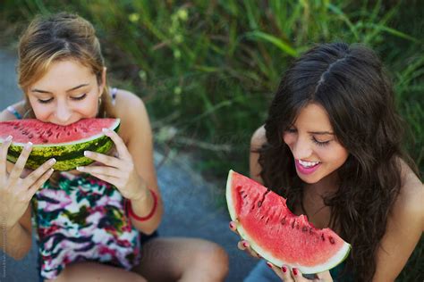Two Female Friends Eating Watermelon Outdoors By Stocksy Contributor Jovana Rikalo Stocksy