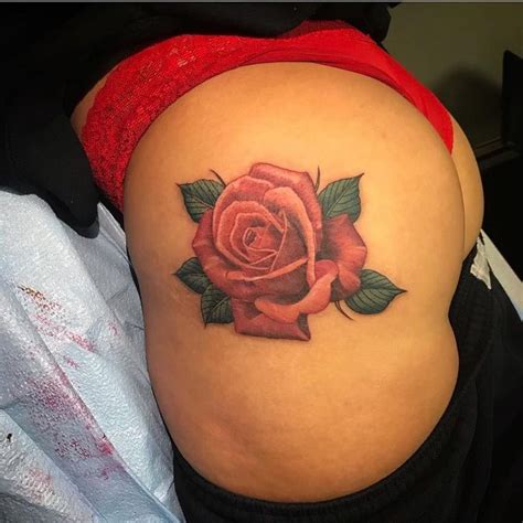 A Womans Stomach With A Rose Tattoo On The Side Of Her Belly