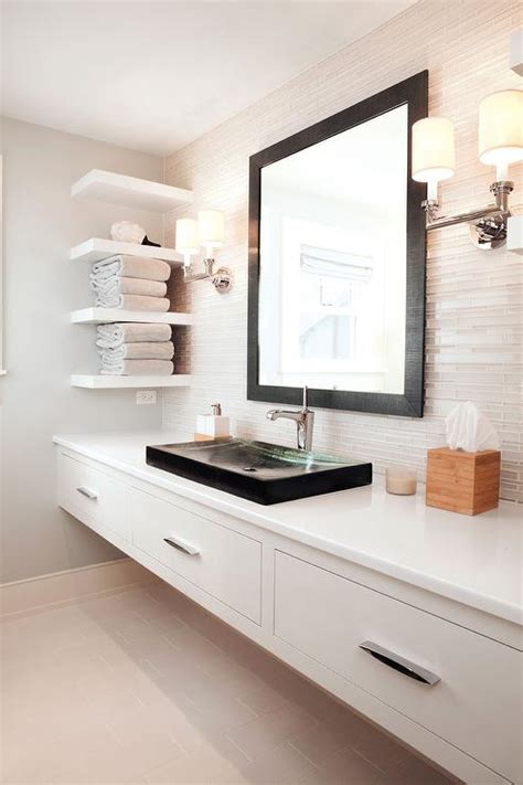 Spacious primary bathroom featuring a white freestanding tub, a couple of shelves and a floating vanity sink. Floating Double Vanity - Modern - bathroom