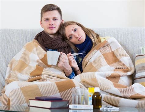 Sick Couple Under Blanket Checking Fever Stock Image Image Of Indoors