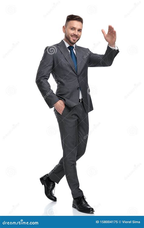 Happy Young Businessman Is Walking And Waving His Hand Stock Image