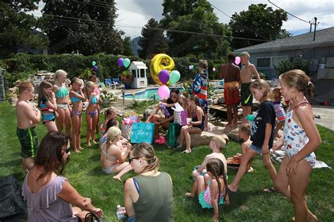 A Backyard Pool Party In The Daytime A Young Girl Opening Ts By