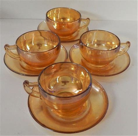 4 Jeanette Glass Co Tea Cups And Saucers Marigold Iridescent Etsy Glass Tea Cups Carnival