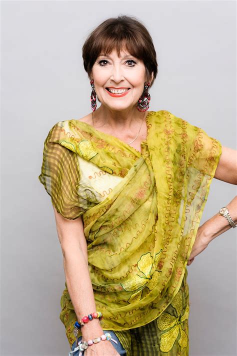 A Woman In A Green Dress Posing For The Camera With Her Hands On Her Hips