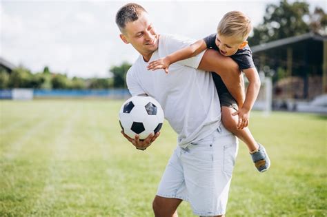 Padre Con Hijo Jugando Al Fútbol En El Campo Foto Gratis