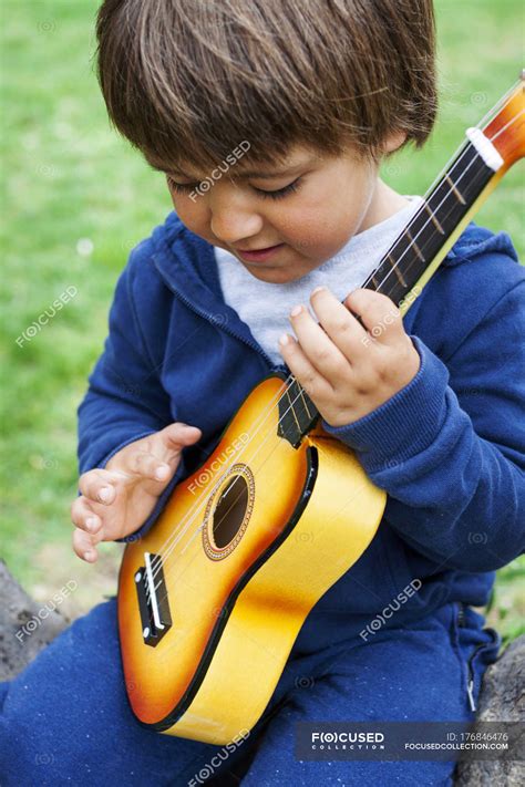 Little Cute Boy Playing Guitar Outdoors — Male Toddler Stock Photo