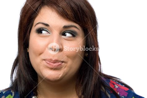A Hispanic Woman Isolated Over White With A Mischievous Look On Her