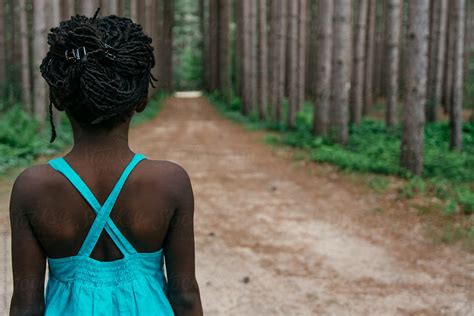African American Girl In Blue Dress On A Road In The Forest By