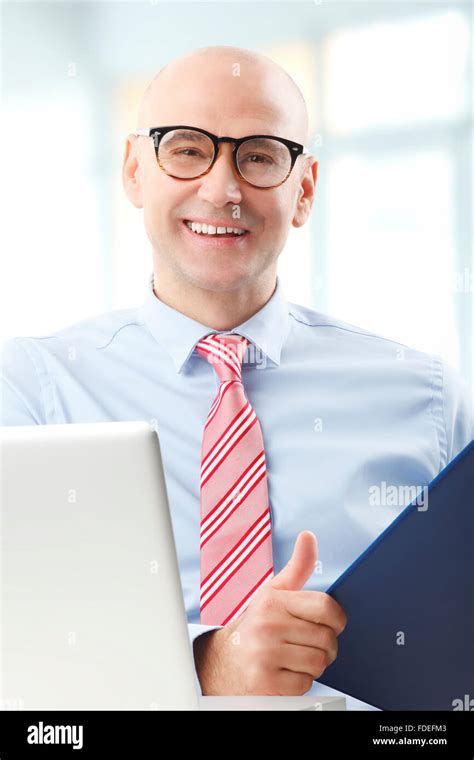 Portrait Of Senior Chief Financier Officer Sitting In Front Of Computer