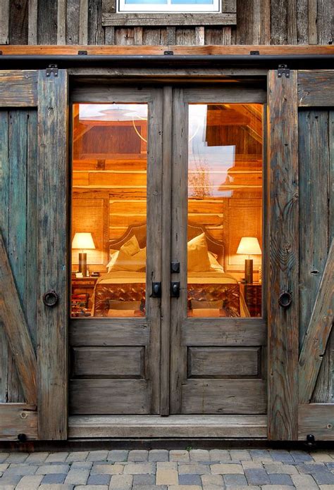 This painting shows horses outside a barn. Sliding Barn Door Ideas to Get The Fixer Upper Look
