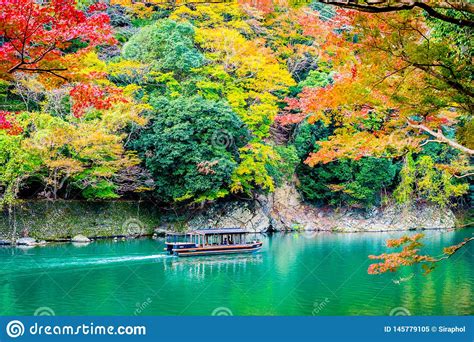 Beautiful Arashiyama River With Maple Leaf Tree And Boat Around Lake