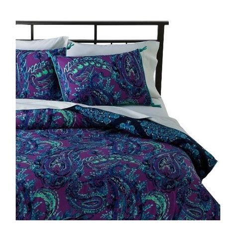 A Purple And Blue Comforter Set With Paisley Print On The Bedding Is Shown