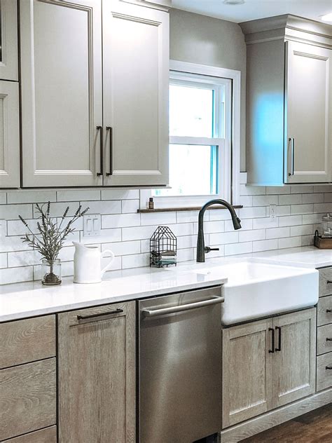 Modern Farmhouse Kitchen With White Subway Tile Painted Upper Cabinets