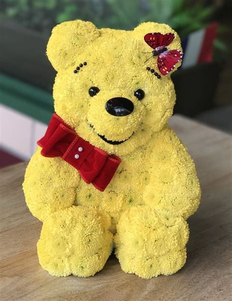 A donkey names eeyore is his friend and kanga and little roo there's rabbit and pigglet then there's owl but most of winne the pooh. Winnie The Pooh | Creative flower arrangements, Animal ...