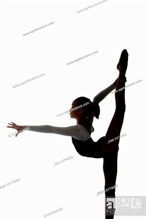 Girl Practicing Gymnastic Pose On Pad Silhouette Stock Photo Picture