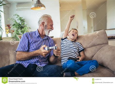 Grandfather And Grandson Are Playing Video Games Stock Image Image Of