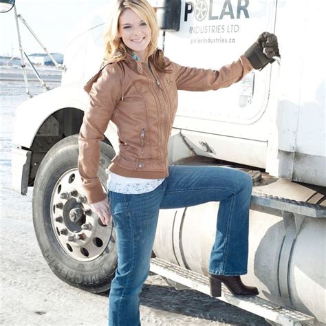 A Woman Standing On The Side Of A Truck With Her Legs Up In The Air