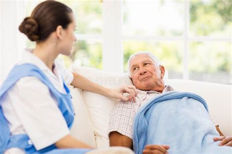 Nurse Taking Care Of Sick Elderly Patient Stock Image Image Of