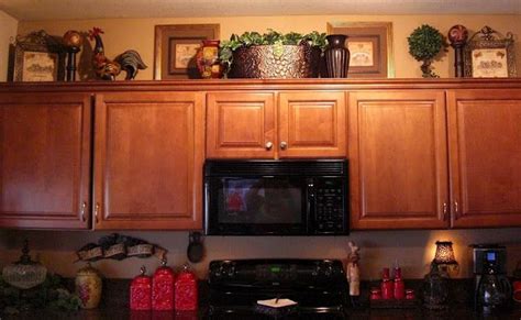 Updating your kitchen doesn't have to cost a lot. Look UP: Decorating the top of a cabinet - Interiors By ...
