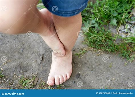 The Feet Of A Small Child On The Ground Walking On Bumps Stock Photo