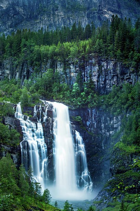 Skjervsfossen Waterfall Surrounded By Pine Forest And Huge Cliffs Near