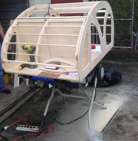 The teardrop features marine plywood panels, epoxy and taped seams, a sculpted fiberglass shell, doors and hatches, and a galley. This Man Made Maggie Her Own Teardrop Trailer.