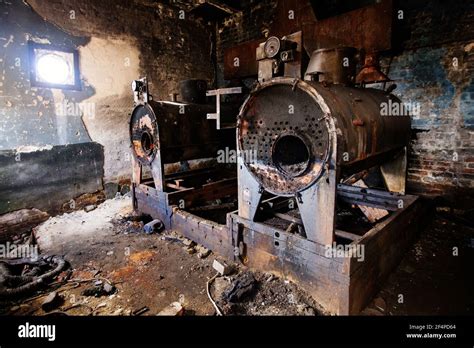 Old Abandoned Boiler Room With Rusty Remnants Of Equipment Stock Photo