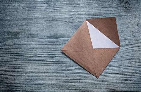 Premium Photo Vintage Opened Envelope With Message On Wooden Board