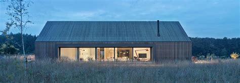 Modern Barn Inspired Home Ages Gracefully In A Wild Poznań Meadow
