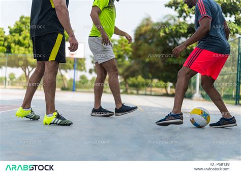 فريق من الاصدقاء العرب الخليجيين السعوديين يلعبون كرة القدم، ممارسة كرة